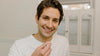 Man smiling holding pill