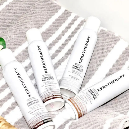 Keratherapy hair care products on a textured surface